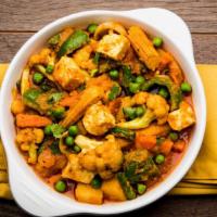 Veggie Curry · Chopped cauliflower, fresh green peas and beans, potato, and carrots cooked with Indian spic...