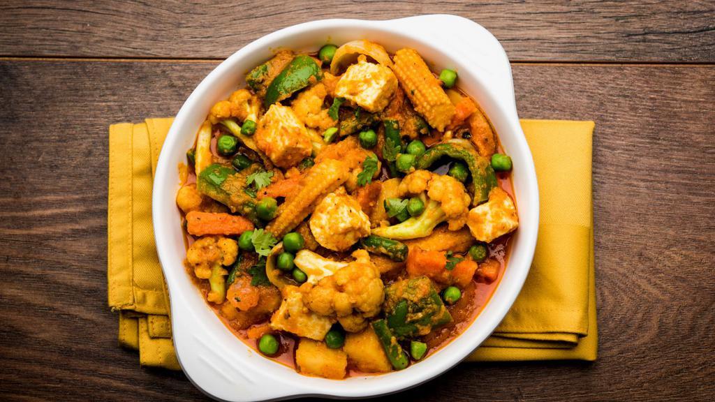 Veggie Curry · Chopped cauliflower, fresh green peas and beans, potato, and carrots cooked with Indian spices and homemade tomato sauce. Served with your choice of rice.