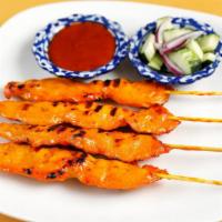Chicken Satay · Tasty marinated chicken on skewers. Served with cucumber salad and our peanut sauce.