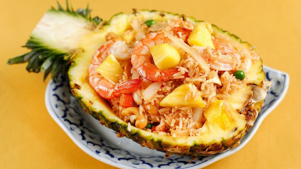 Pineapple Fried Rice (Vegetarian) · Recommended. Prawns and chicken, white onions, cashew nuts, pineapple, carrots, green beans. Served in a pineapple shell.