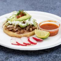 Sopes · A thick handmade tortilla topped with beans, sour cream, cheese, and your choice of meat.
