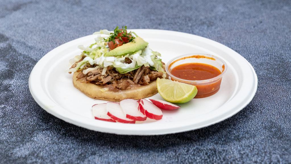Sopes · A thick handmade tortilla topped with beans, sour cream, cheese, and your choice of meat.