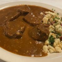 Hungarian Goulash · Choice beef chunks cooked in paprika sauce and spaetzle.