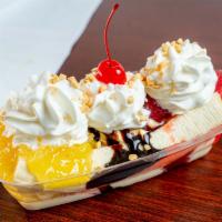 Famous Banana Split · 6 oz. vanilla ice cream topped with strawberry, chocolate, and pineapple sandwiched between ...
