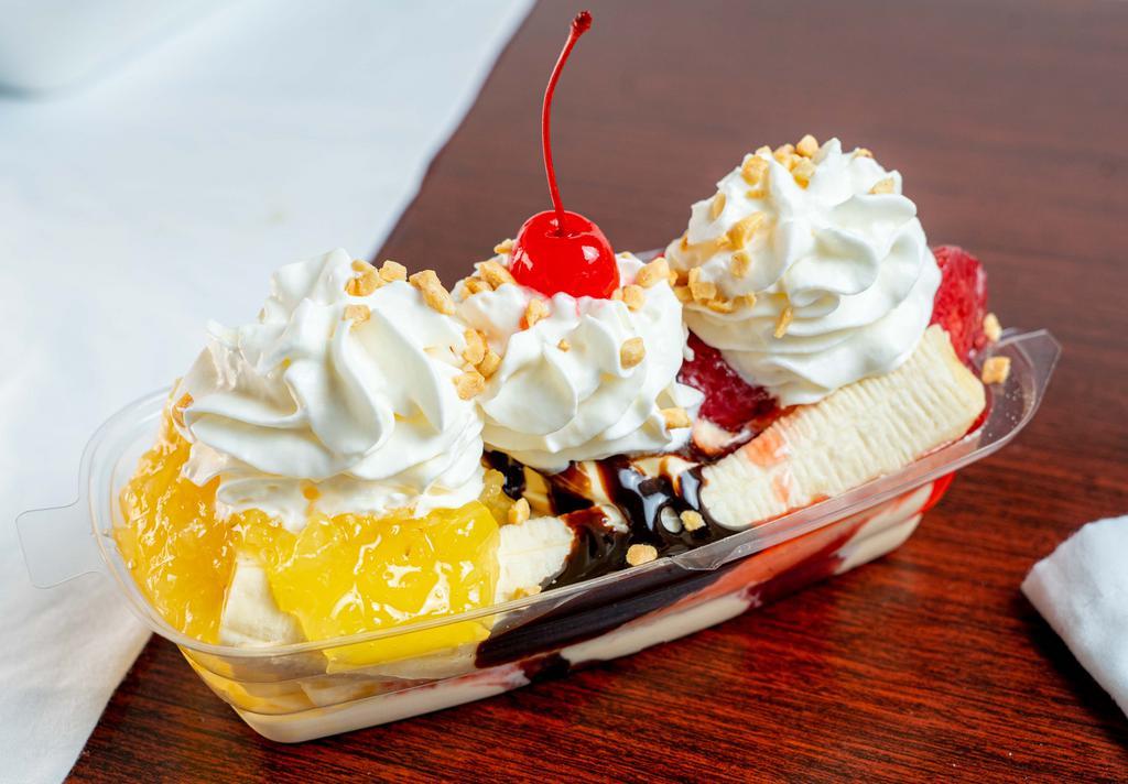 Famous Banana Split · 6 oz. vanilla ice cream topped with strawberry, chocolate, and pineapple sandwiched between a long cut banana. Topped with whipped cream, nuts, and a cherry.