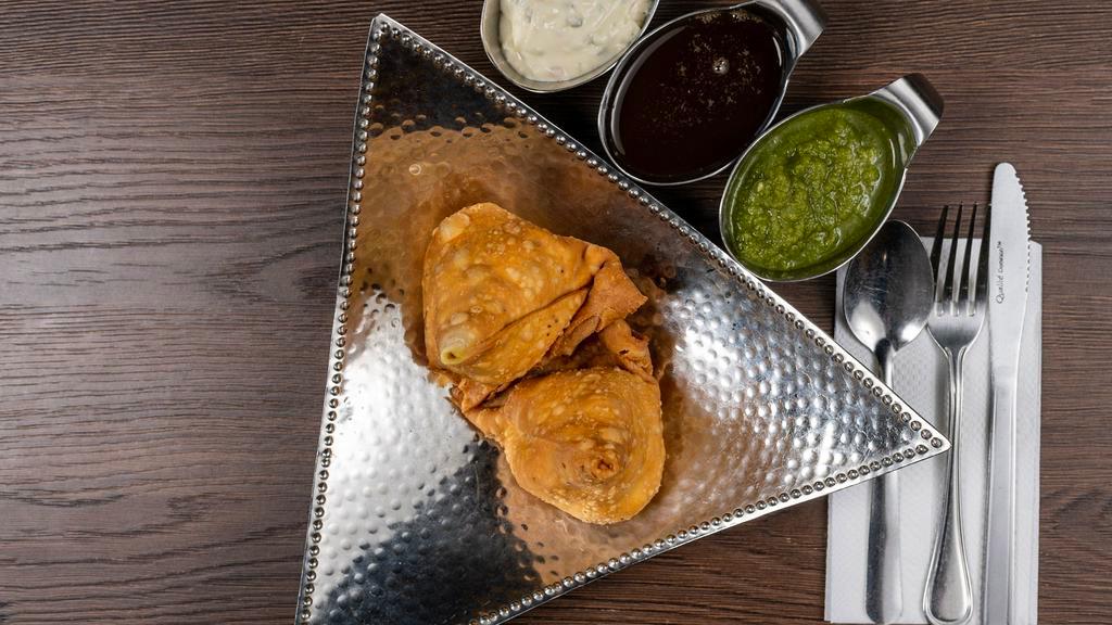 Cocktail Samosa (4pcs) · Traditional Indian crispy patties stuffed with potatoes and peas.