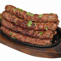Lamb Seekh Kabab · Mixed lamb made with spices, put on a skewer and roasted in tandoor.
