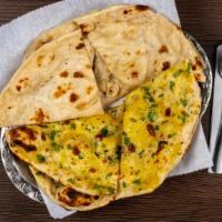 Garlic Naan · Leavened white bread with fresh garlic and cilantro layered on top and baked in tandoor.