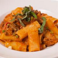 Rigatoni Rustica · Tube-shaped pasta with ground sausage, bell peppers, green peas, and mushrooms, in a tomato ...