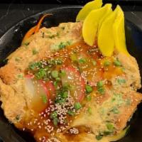 Katsu Donburi · Breaded lean pork loin deep fried, vege. and eggs simmered with house sauce.