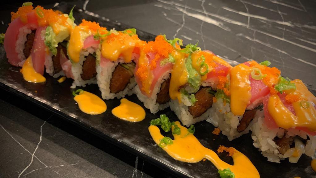 In and Out · Spicy tuna roll topped with tuna and avocado and fish egg. Sauce - spicy mayo.