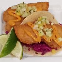 Beer Battered Fish Taco · Beer battered Alaskan cod served with pineapple salsa and pickled purple cabbage on a grille...