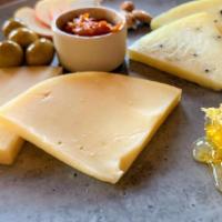 Cheese Plate · Design your own plate of imported Spanish cheeses. Accompaniments include olives, candied al...