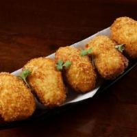 Croquetas De Jamón · fried béchamel croquettes flavored with spanish ham, egg and chicken.