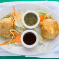 Samosas · (2 pcs) crisp patties filled with spiced potatoes and peas. Served with mint-cilantro and ta...