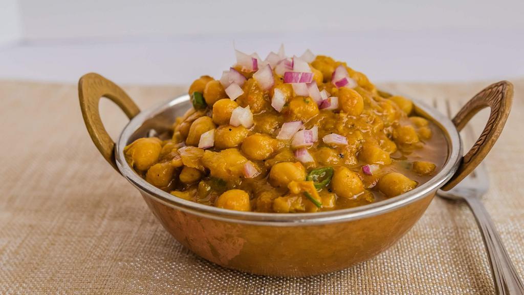 Chana Masala · Garbanzo beans cooked in house blend curry sauce.