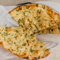 Garlic Naan · Tandoor baked bread with minced garlic and cilantro.