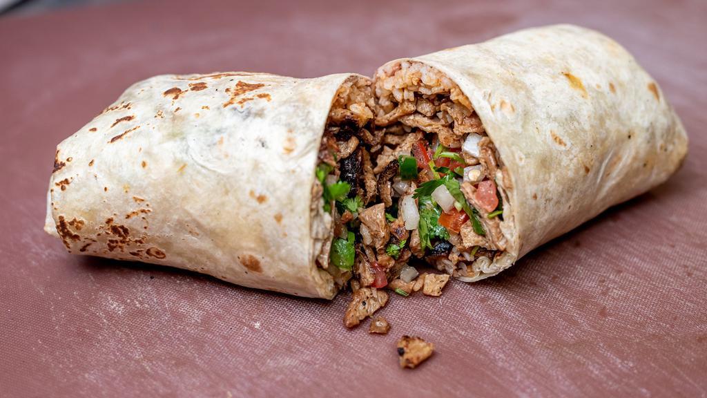 Carne Asada Burrito · The carne asada burrito contains venganza vegan carne asada, refried pinto beans, mexican rice, pico de gallo, guacamole, salsa.