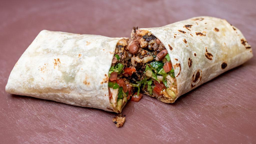 Carnitas Burrito · The carnitas burrito contains Venganza vegan carnitas, refried pinto beans, Mexican rice, pico de gallo, guacamole, salsa, onion.