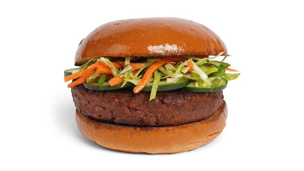 The Bahn Mi Burger · Beef patty with shredded carrot slaw, cilantro, sliced jalapenos, cucumber, and spicy mayo on a fluffy brioche bun.