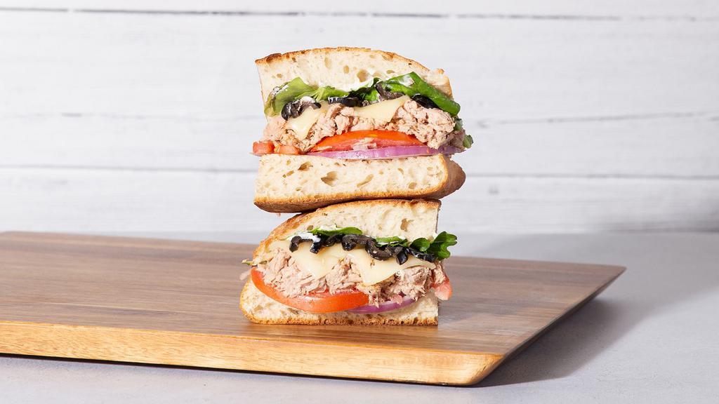 Tuna Melt · Albacore tuna salad with melted cheddar cheese, sliced tomato, mixed greens, and aioli on your choice of bread.