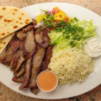 #1. Gyro Plate · Thin marinated slices of gyro meat over saffron rice with side of salad, pita bread & cucumb...