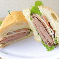 Nortonville · Roast beef thinly sliced on a roll, jack cheese, leaf lettuce, mayo, tomato and sweet red on...