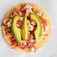 Ceviche Tostada · Fish or shrimp marinated in lime, cilantro, onions, tomato, peppers, cucumber, and avocado.