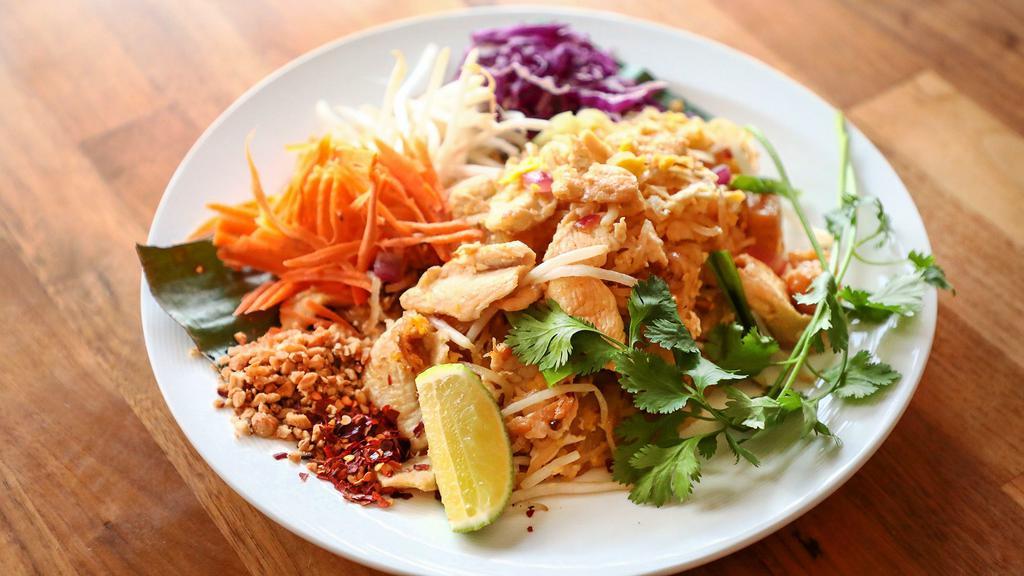 Pad Thai · Bangkok style fresh thin rice noodle with choice of protein, tofu, pickled daikon, eggs, bean sprouts, red and green onions, sautéed with sweet and sour tamarind sauce, topped with peanut