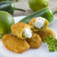Jalapeño Poppers · Hollowed out jalapeño, stuffed with a mixture of cheese, breaded and fried.
