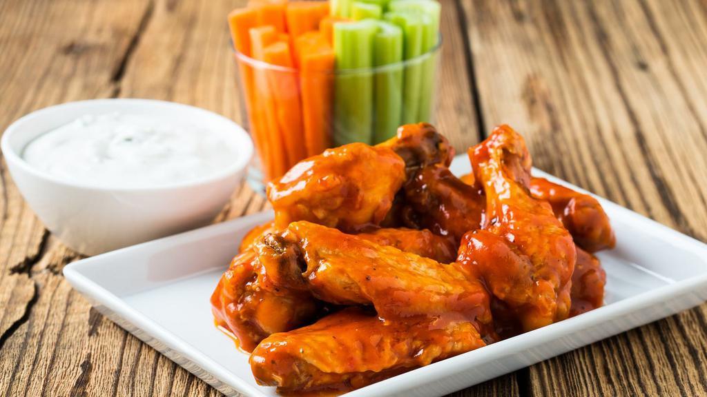 Spicy Buffalo Wings · Baked wings smothered in our spicy buffalo wing sauce served with ranch.