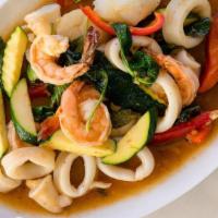 Pad Talay Ruam Mit · Sizzling stir-fried mixed seafood of  prawns, squid, scallop, onions, zucchini, chili, fresh...