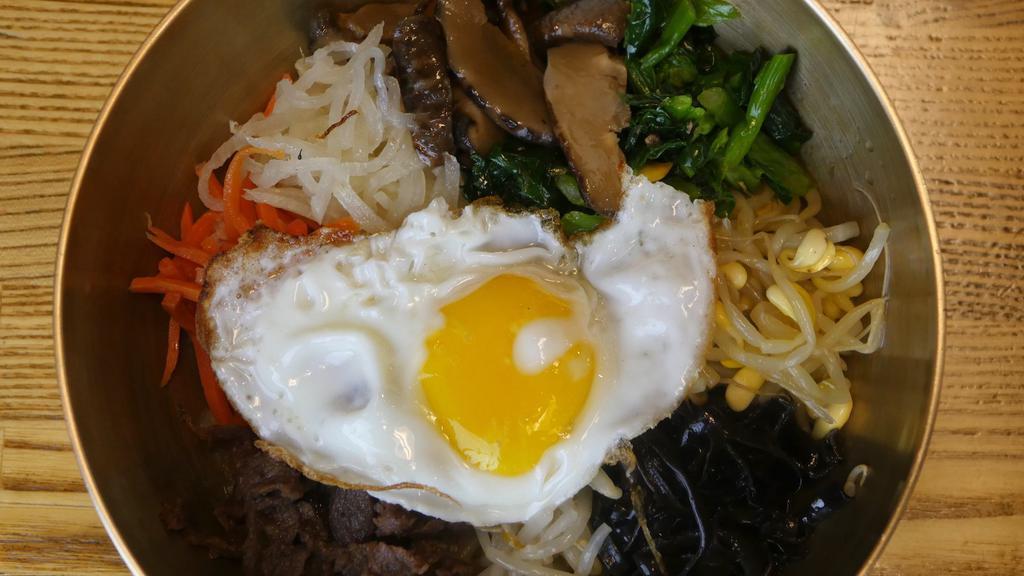 Bibimbap · Not served on hot stone. Bean sprouts, soybean sprouts, radish, rape, mushroom, and carrots over rice and sesame oil. Topped with fried egg, sliced beef and sesame seeds.