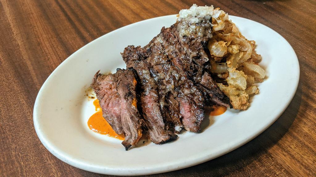 Grilled Skirt Steak · manchego, onions rings, mojo Colorado.