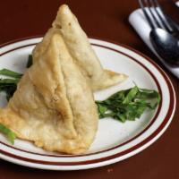 Samosa · Two pieces. Medium turnover stuffed with potatoes and green peas.
