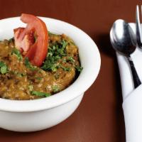 Dal Makhani · Black lentils prepared in light cream and a touch of butter and garnished with tomatoes, oni...
