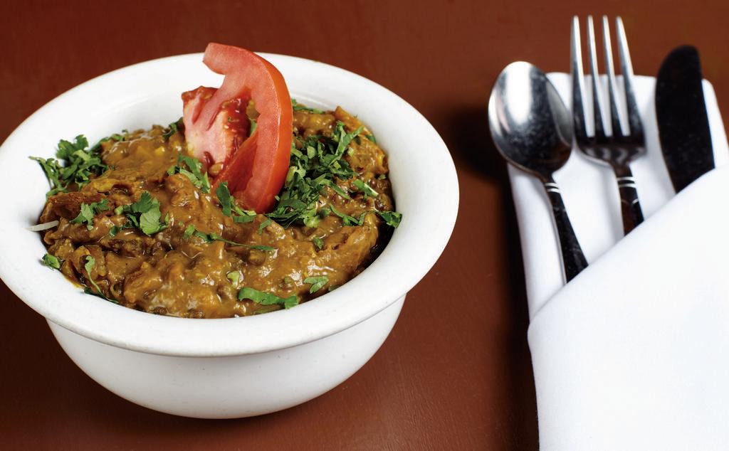 Dal Makhani · Black lentils prepared in light cream and touch of butter and garnished with tomatoes, onions, and ginger.