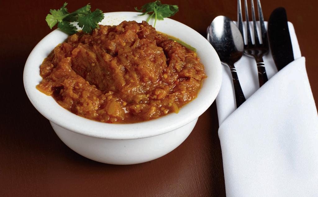 Bangan Bharta · Roasted eggplant cooked with fresh tomatoes, onions, and green peas.