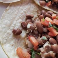 Tacos De Carne Asada or Carnitas · Three tacos with beans and pico de gallo.