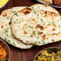 Paneer Naan · Fresh baked naan topped with pieces of paneer cheese.