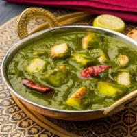Palak Paneer · Spinach and cheese cooked with exotic spices for a rich tasting curry.