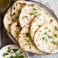 Onion Naan · Fresh rolled dough baked to a delightful perfection in the tandoor topped with fried onions.