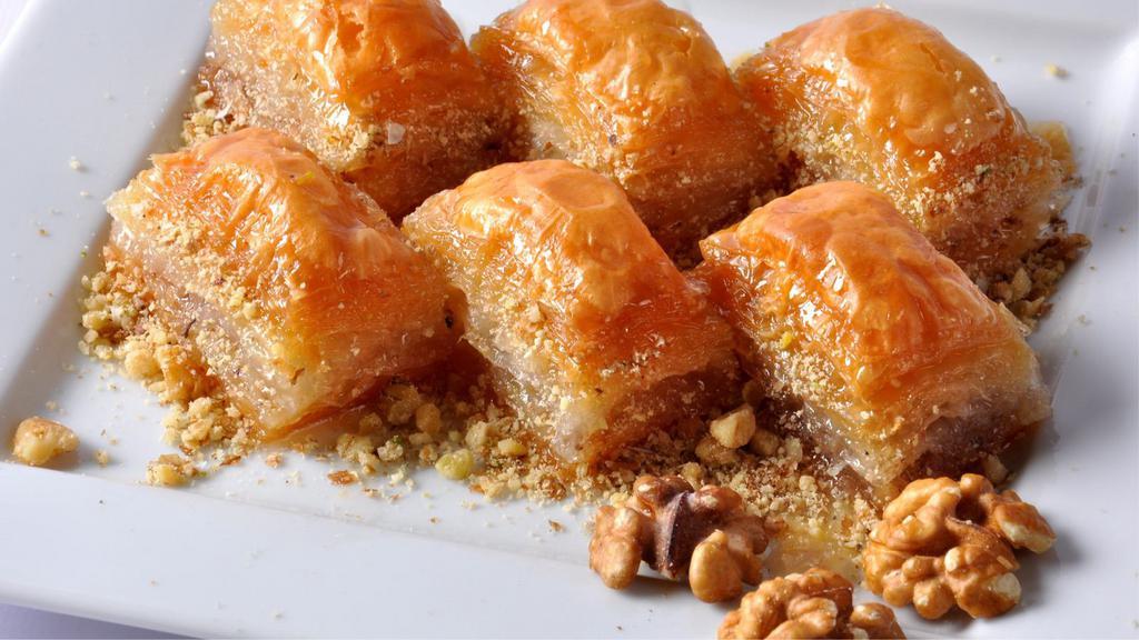 Walnut Baklava · Tender walnuts nestled in layers of buttery flaky filo dough made with honey.