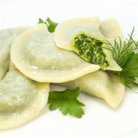 Vegetable Momo (6) · Six pieces of steamed dumplings stuffed with fresh vegetables.