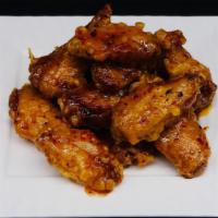 Dry Fried Chicken Wings · Eight deep fried chicken wings or diced in rich sauce with garlic, ginger and roasted red pe...