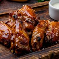 Bbq Wings · Features traditional, fire grilled chicken wings topped with tangy BBQ sauce.