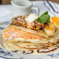 Banana Souffle Pancake · Vanilla curd, candied walnut, grilled banana and maple syrup.