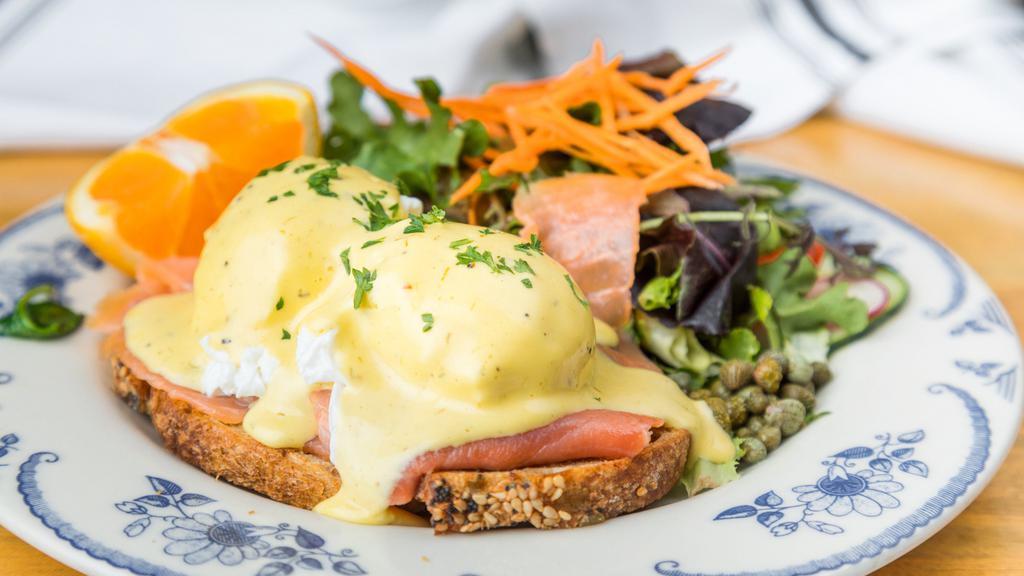 Norwegian Benedict · Smoked salmon, garlic sauteed spinach, caper, chive hollandaise, and grilled miche.