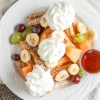 French Toast ‘n’ Fruit · Six triangles topped with fresh fruit (in season) and sprinkled with powdered sugar.