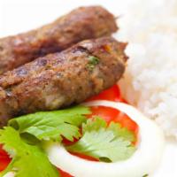 Lamb Seekh Kabob with Rice · Delicious marinated juicy ground lamb cooked in clay.
